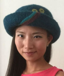 Isabelle wearing a felted wool hat handcrafted by fiber artist Maria Nitzsche of Vermont Hats.