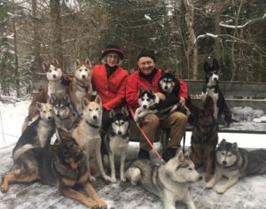 Vermont Hats customer Debbie of Wallingford, Vt wearing her Vermont Hats hat with her husband and dogs